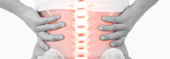 Hands support a lower back area with an emphasized spine, illustrating pain or spinal strain.