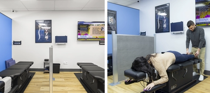 Clinic interior featuring treatment tables, educational spine posters, and a patient receiving care.